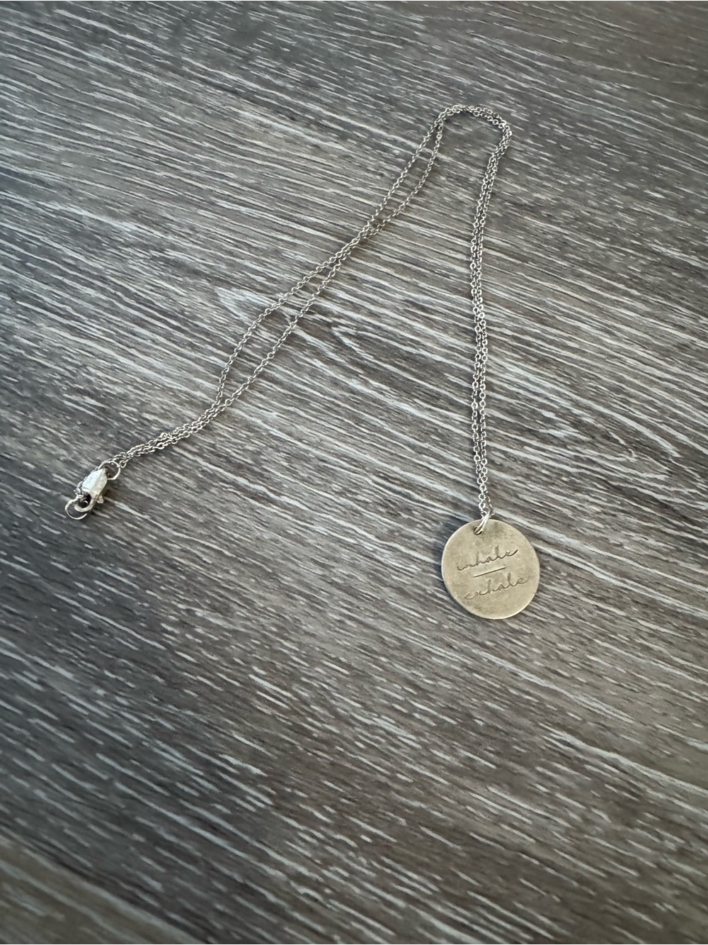 Inhale exhale silver chain necklace with round pendant